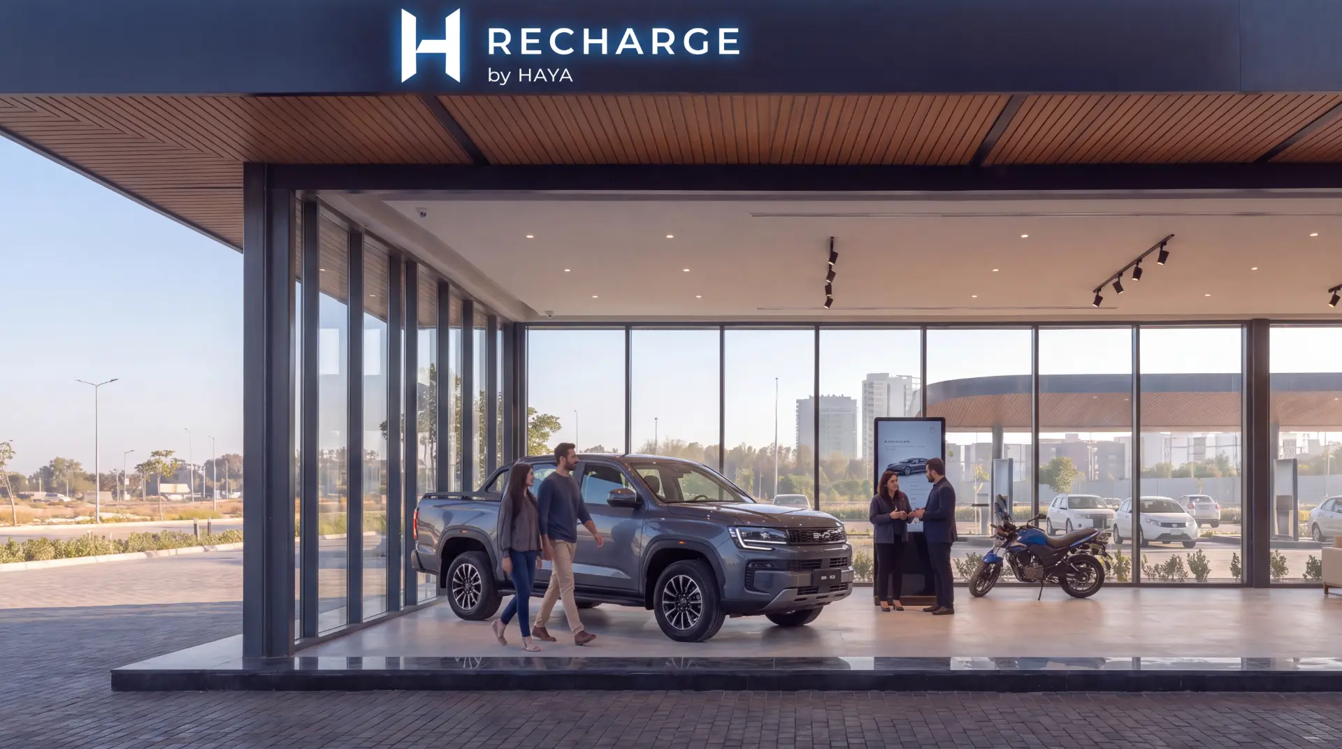 HAYA Discover showroom with a BYD Shark electric pickup truck on display and guests exploring the space